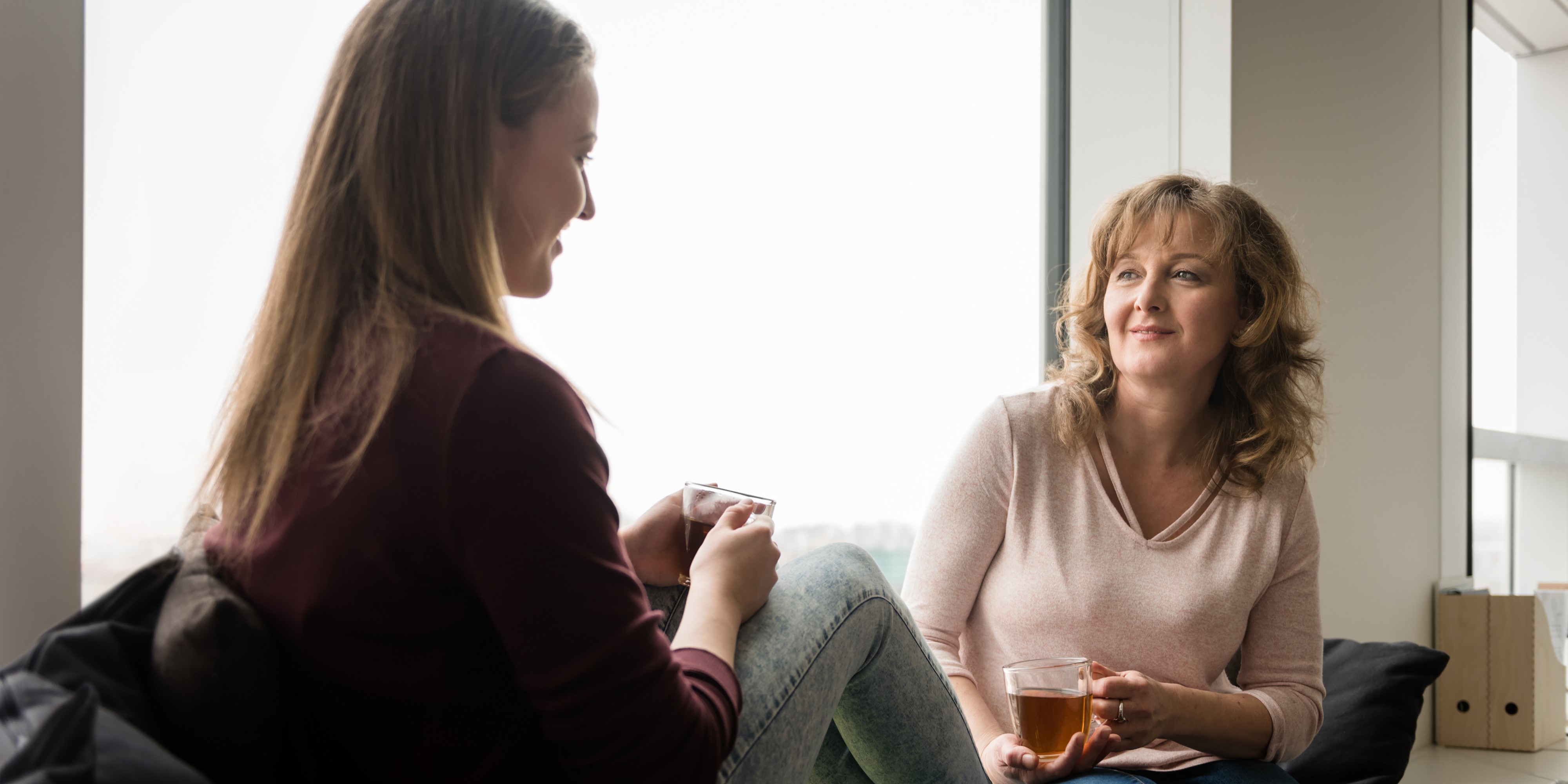Support worker chatting with lady drinking tea