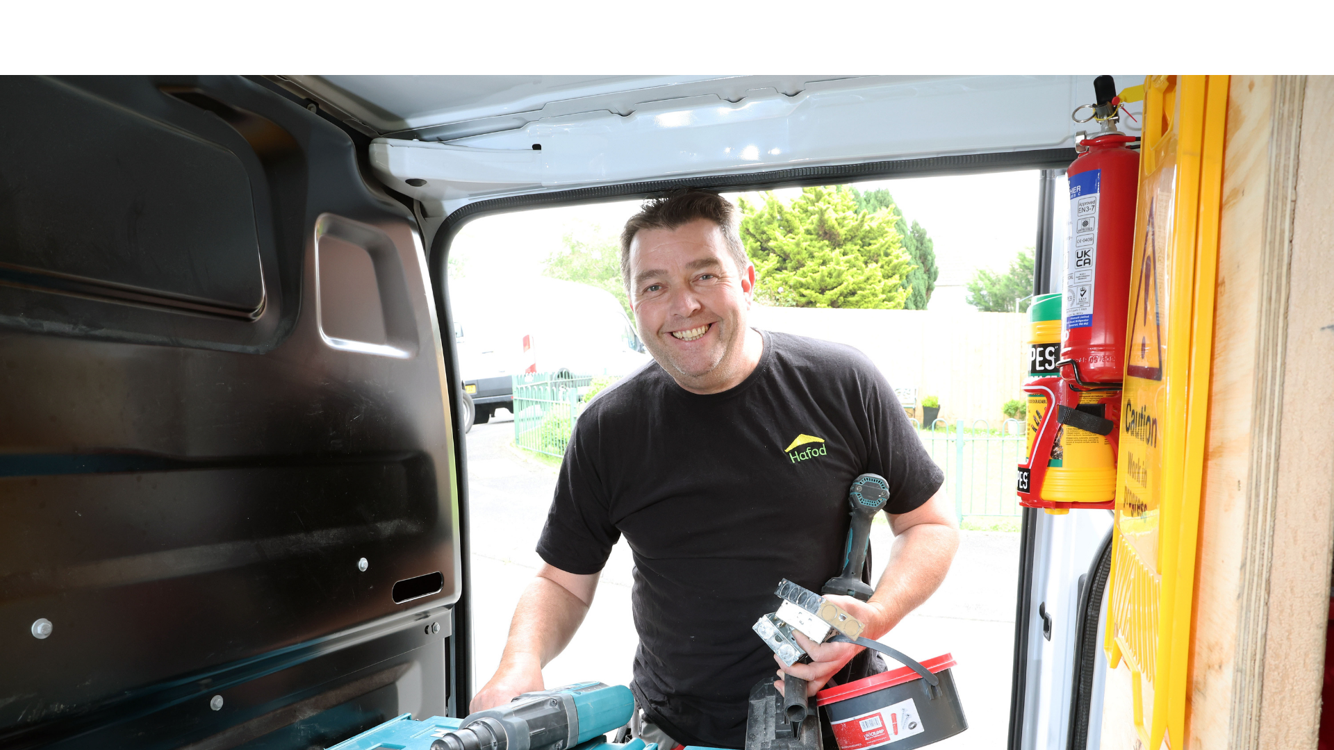 Man with tools by a van