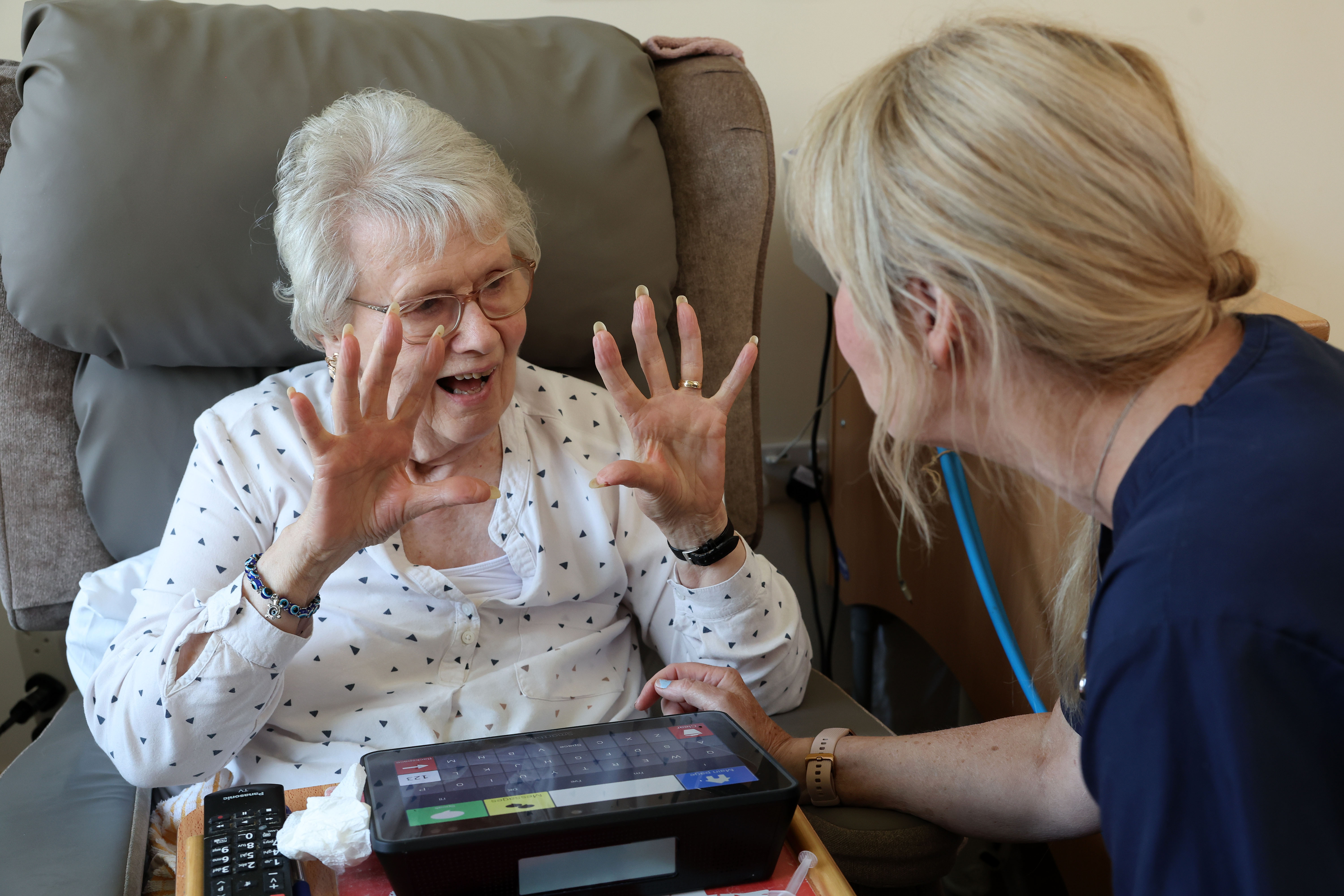 Resident and Carer having a conversation using a communication aid