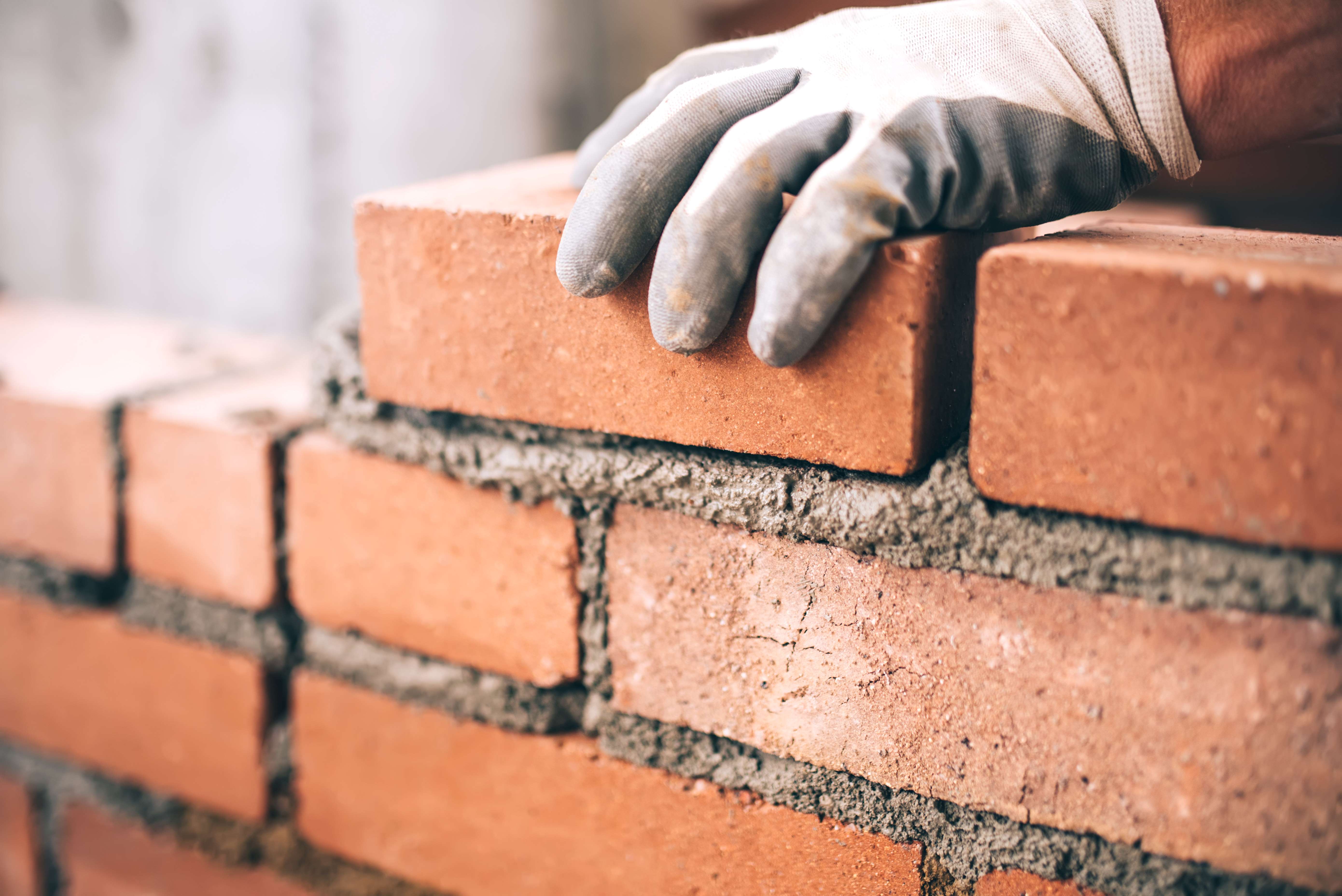 Builder laying bricks