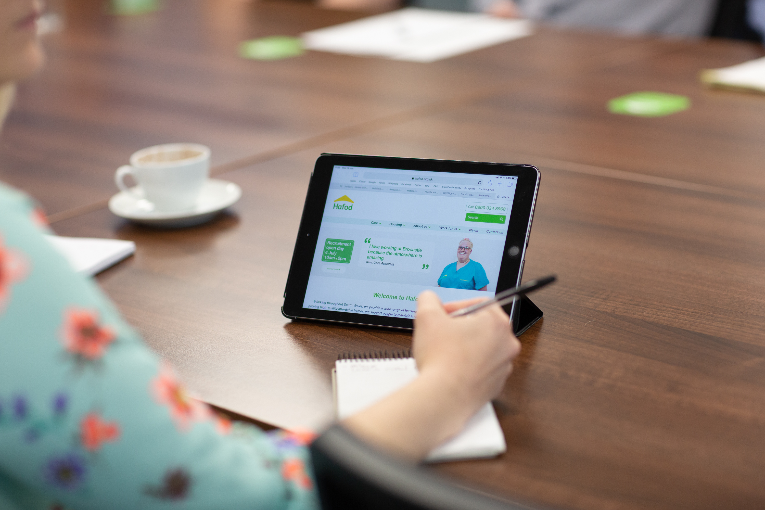 Tablet device being used during a meeting in head office