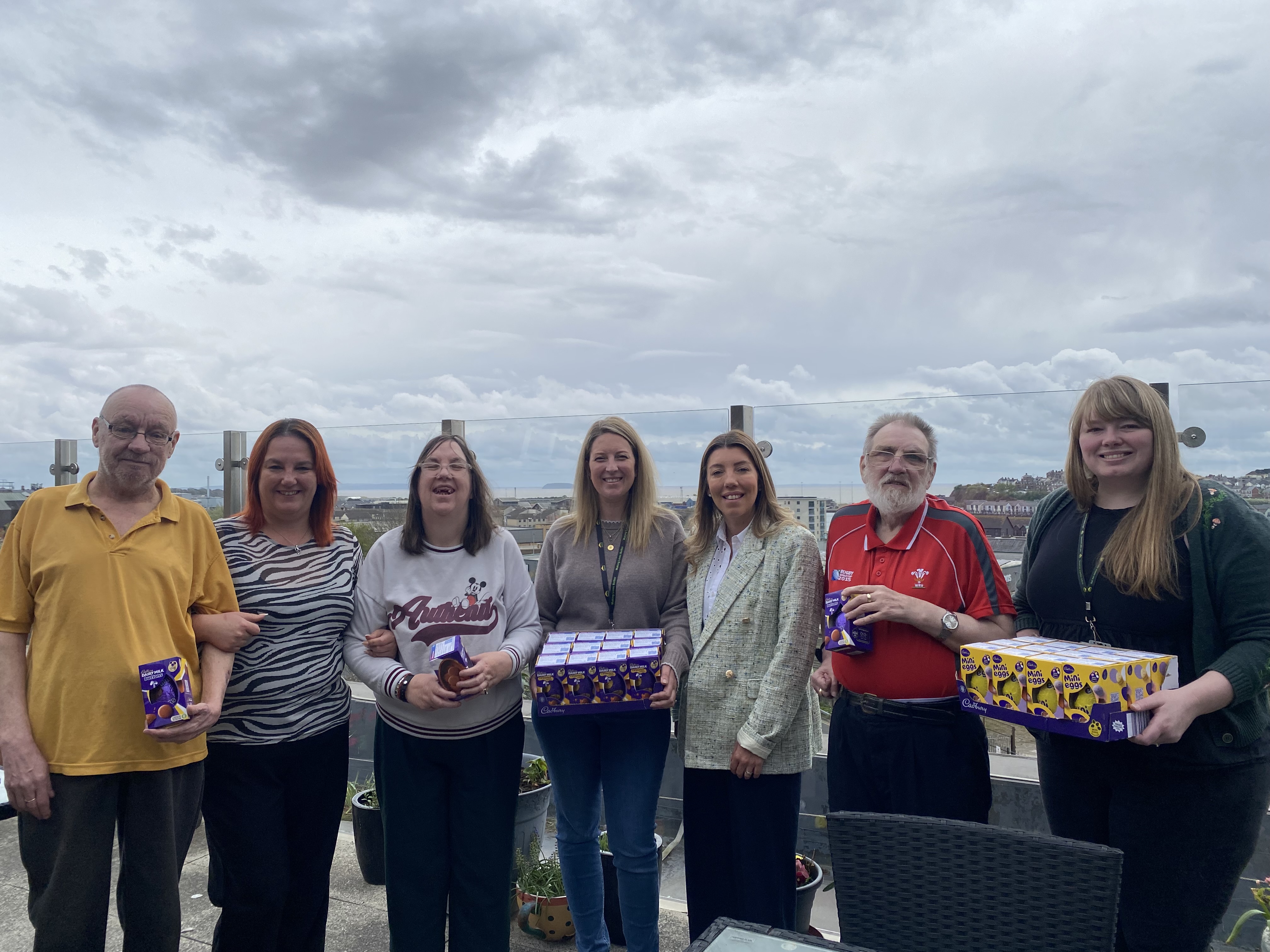 Customers and colleagues at Golau Caredig receiving an Easter egg donation
