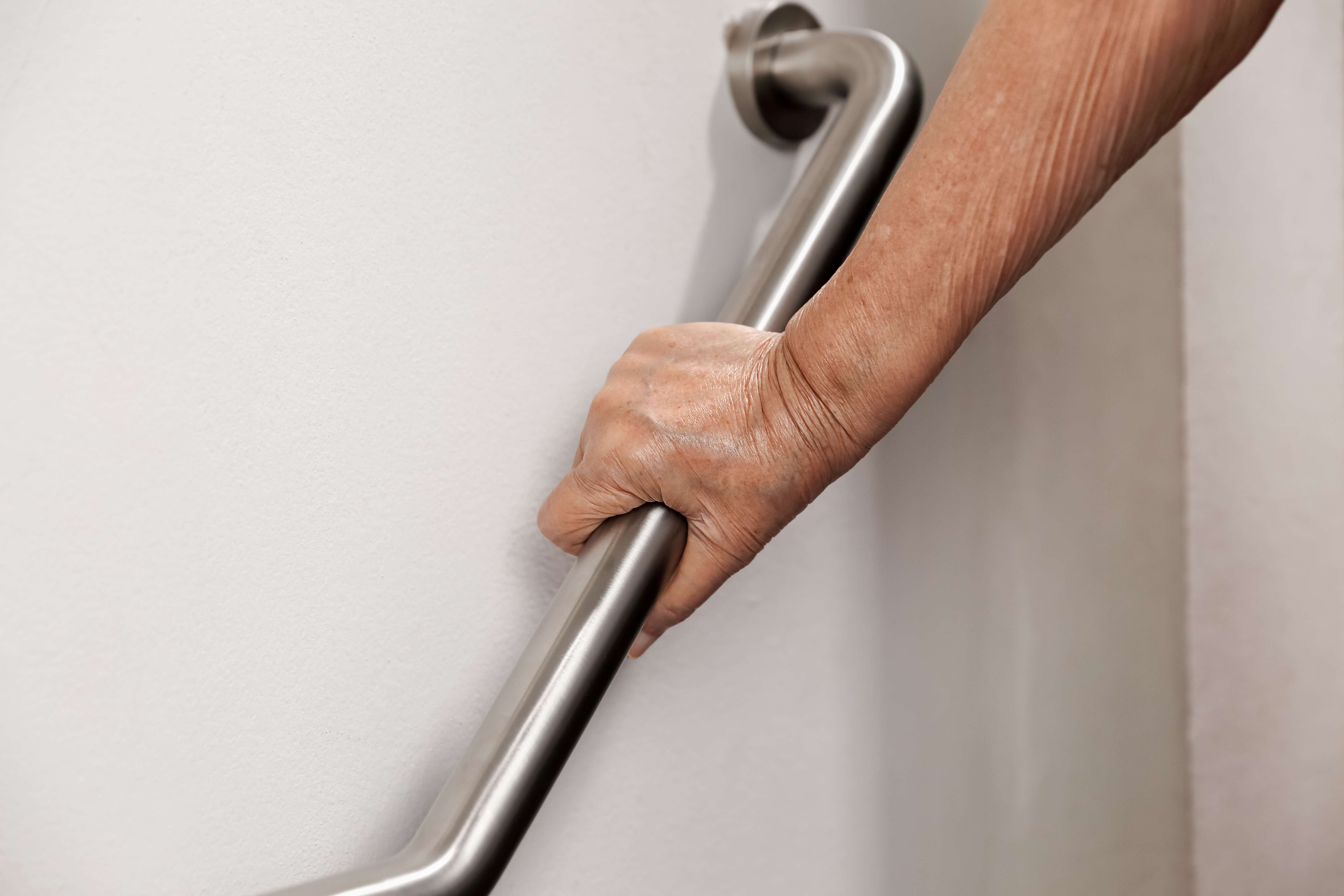 Woman using handrail