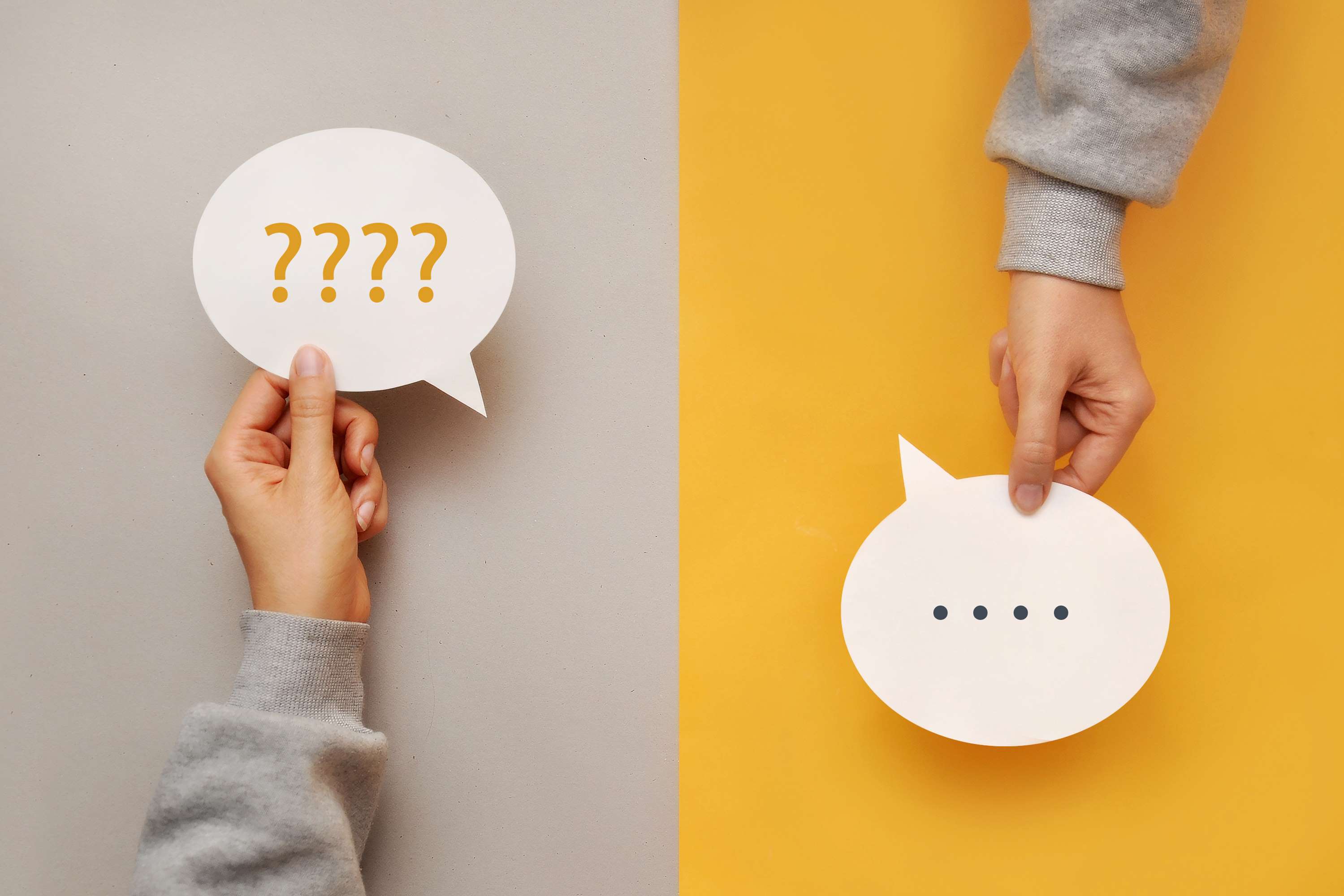 Person holding a question mark and another person holding a speech bubble in answer
