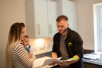 Contract holder chatting with their neighbourhood coach in their new kitchen