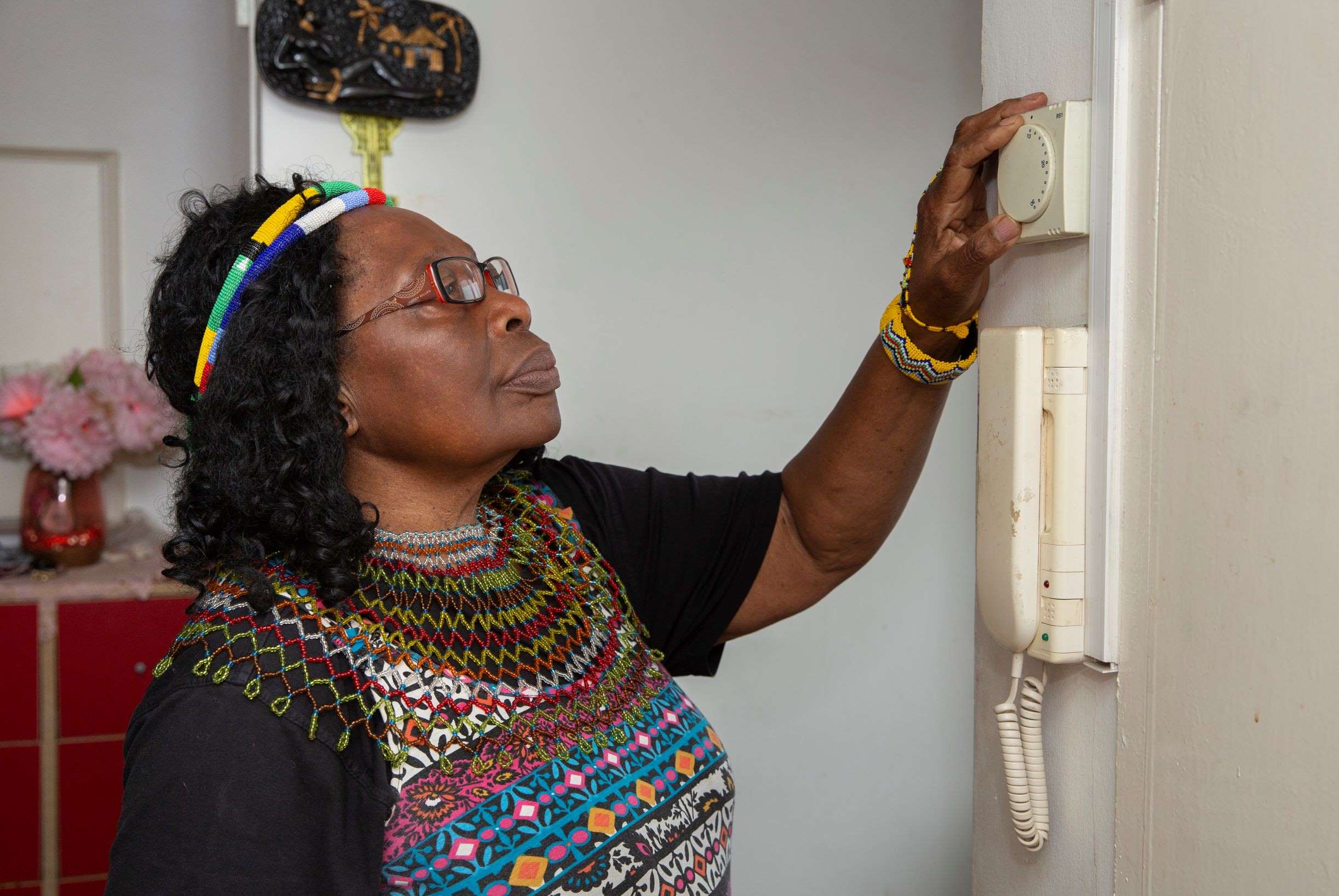 Lady adjusting thermostat