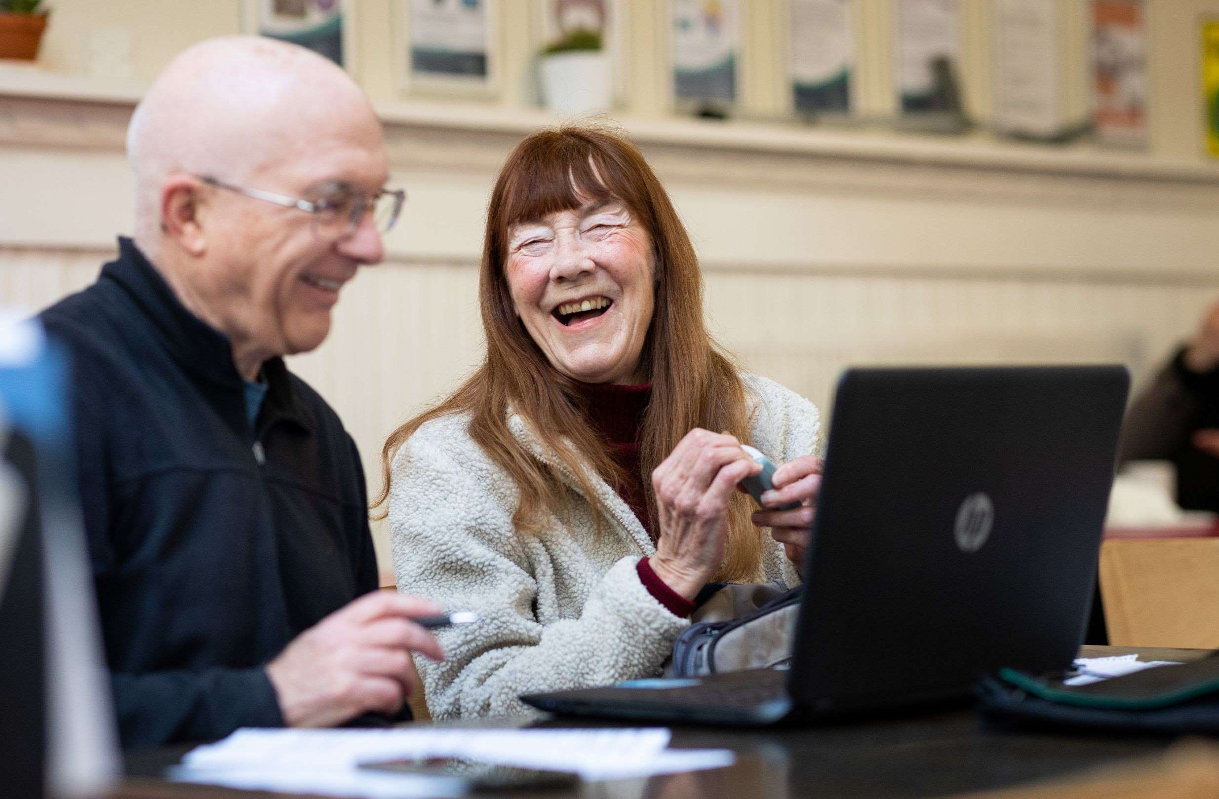 Lady learning how to use a laptop