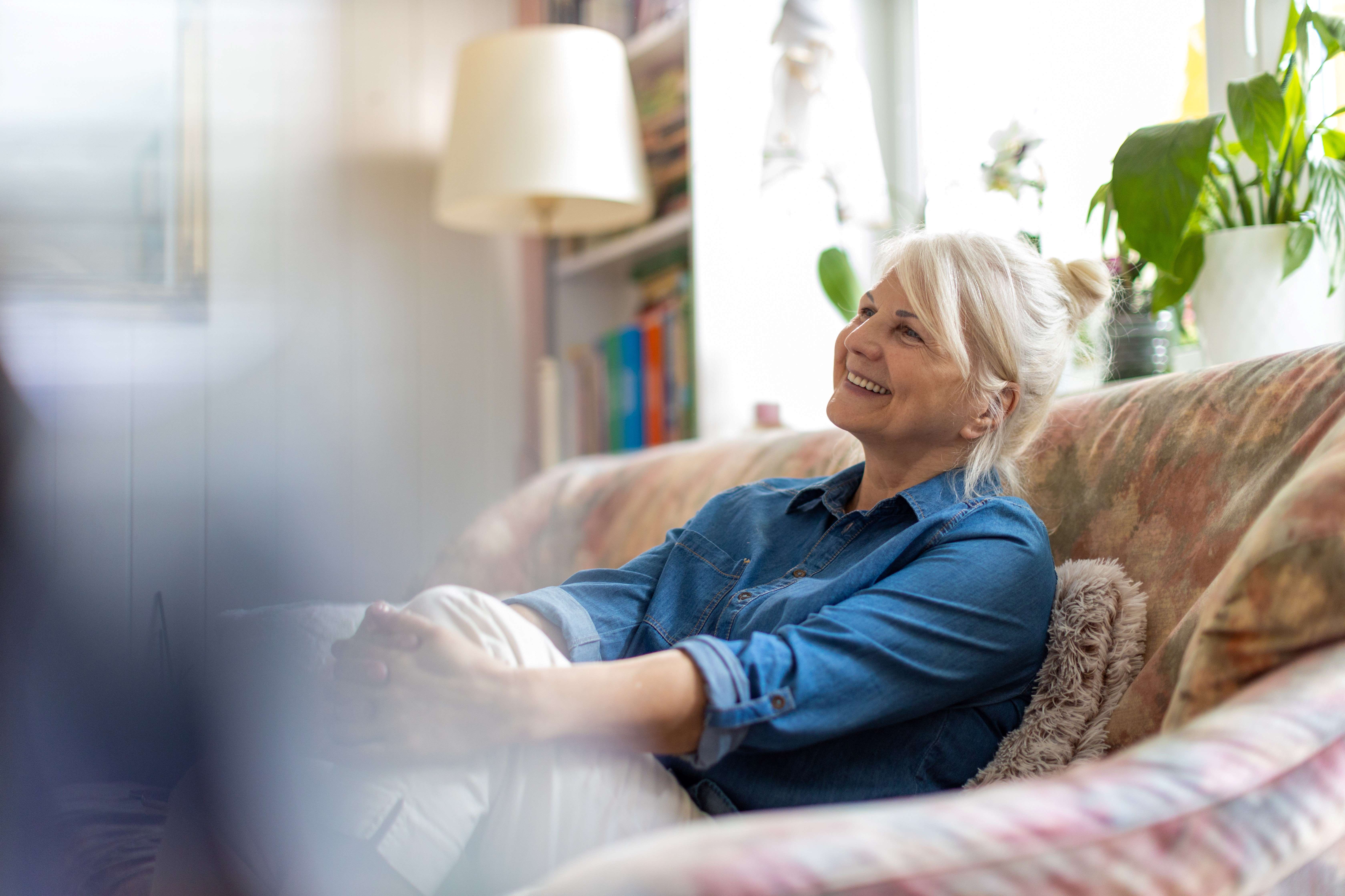 Lady sitting on her sofa at home