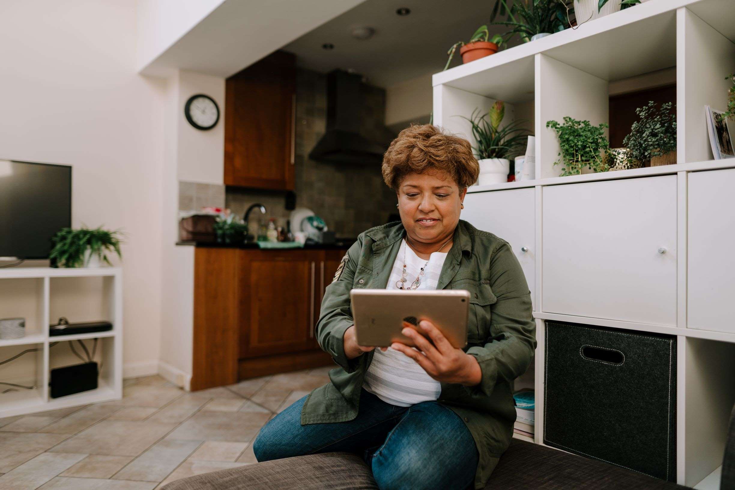 Lady using her tablet on the sofa