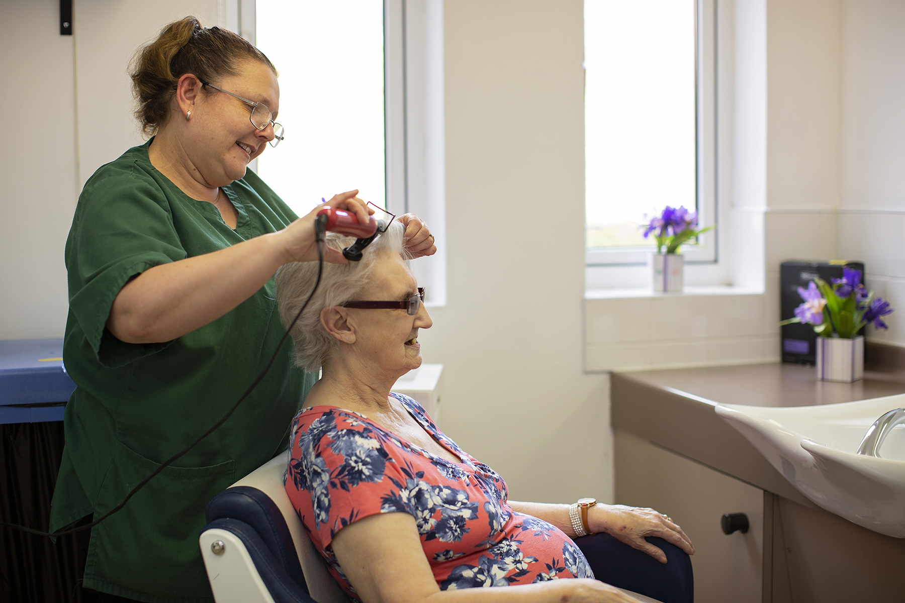 Resident having her hair done at Plas y Garn Care Home
