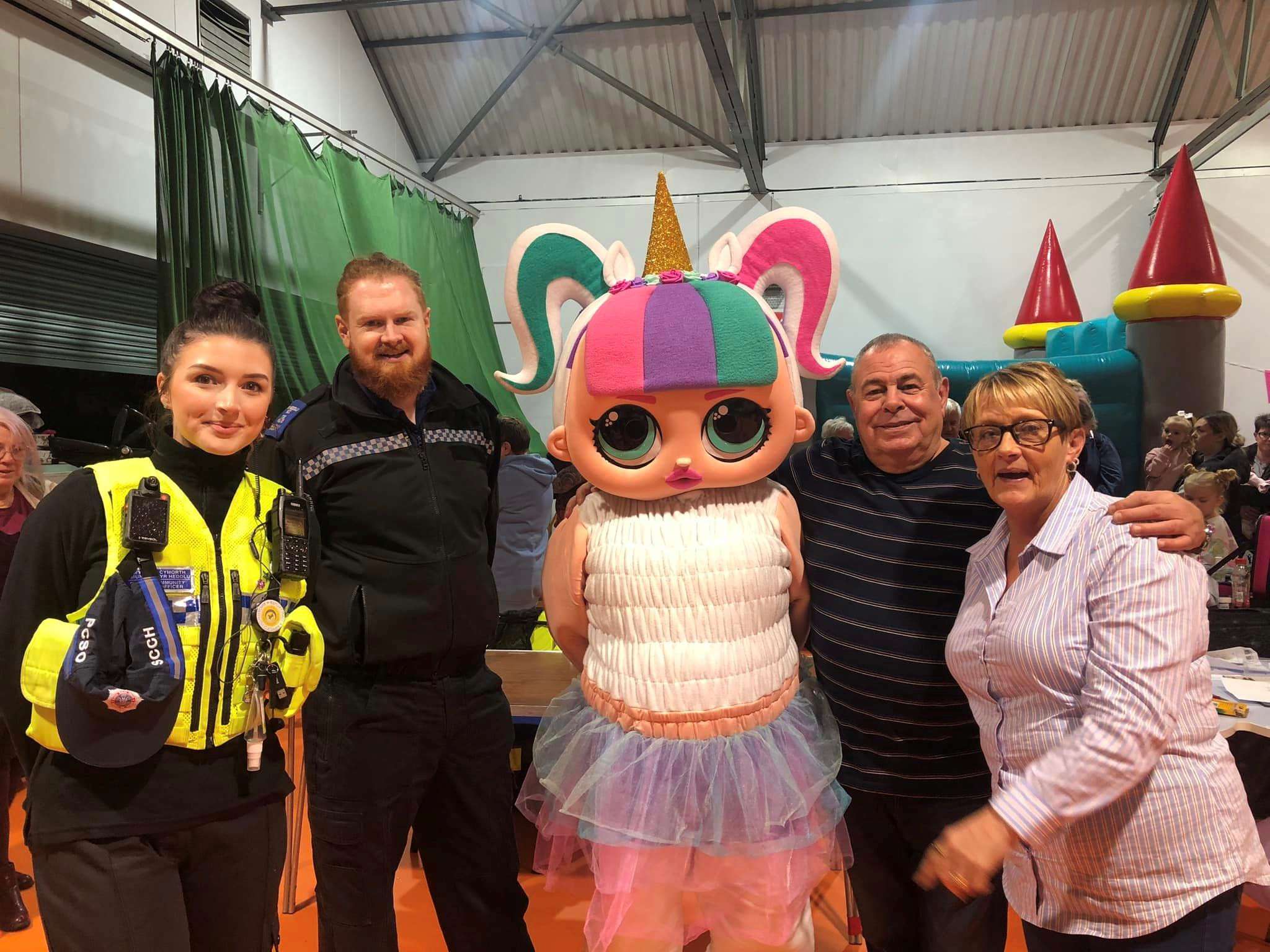 A group of colleagues, customers and local police officers at a community event in Treharris