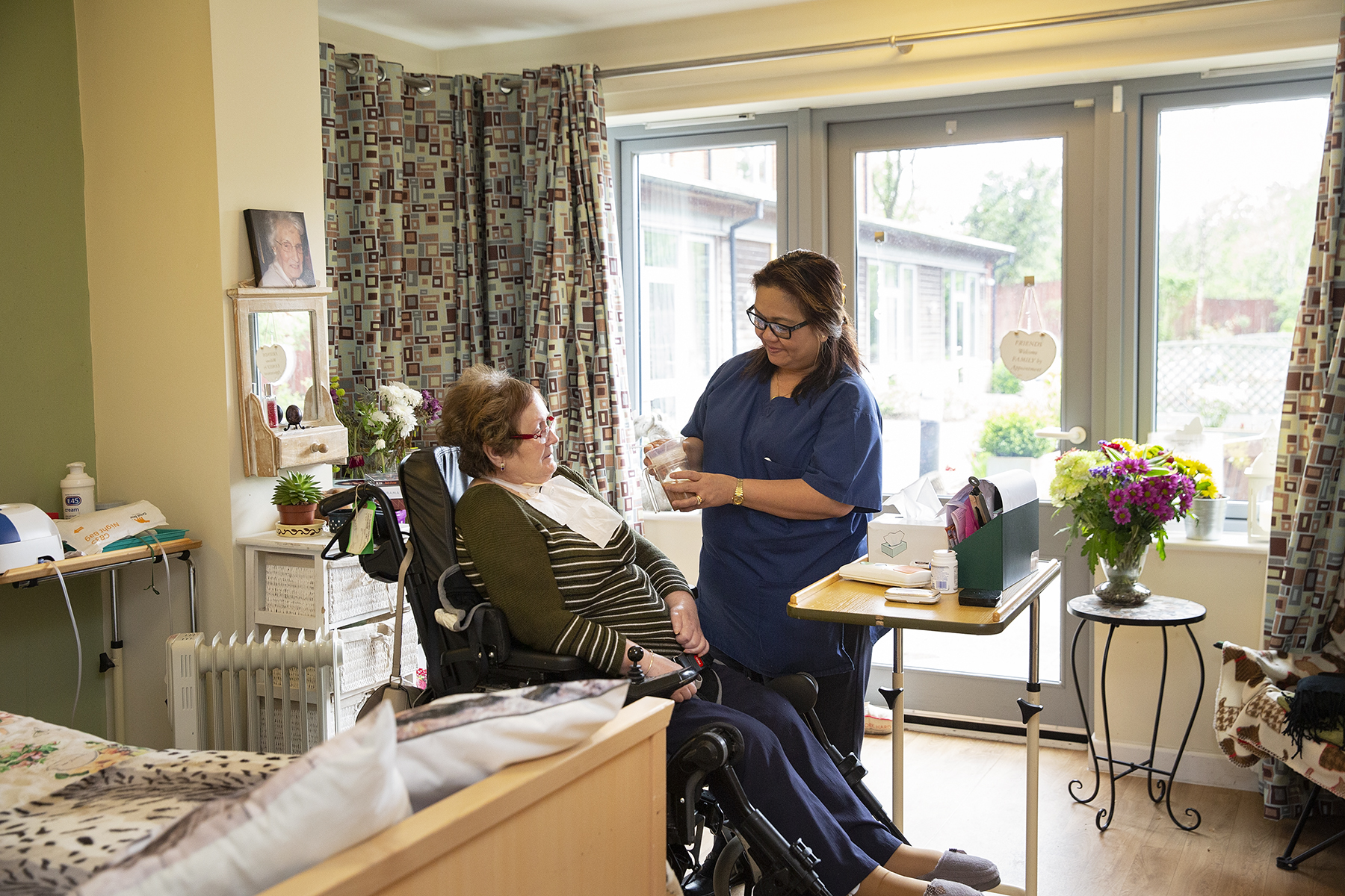 Resident and carer at Tŷ Penrhos Care Home
