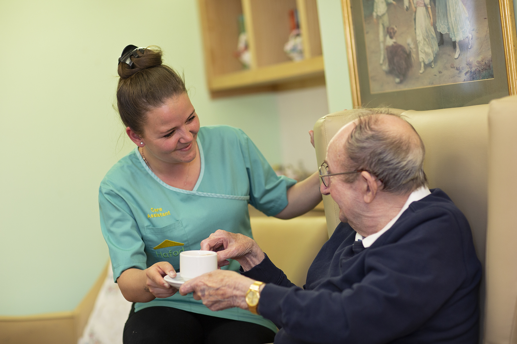 Carer chatting with resident at Woodcroft Care Home