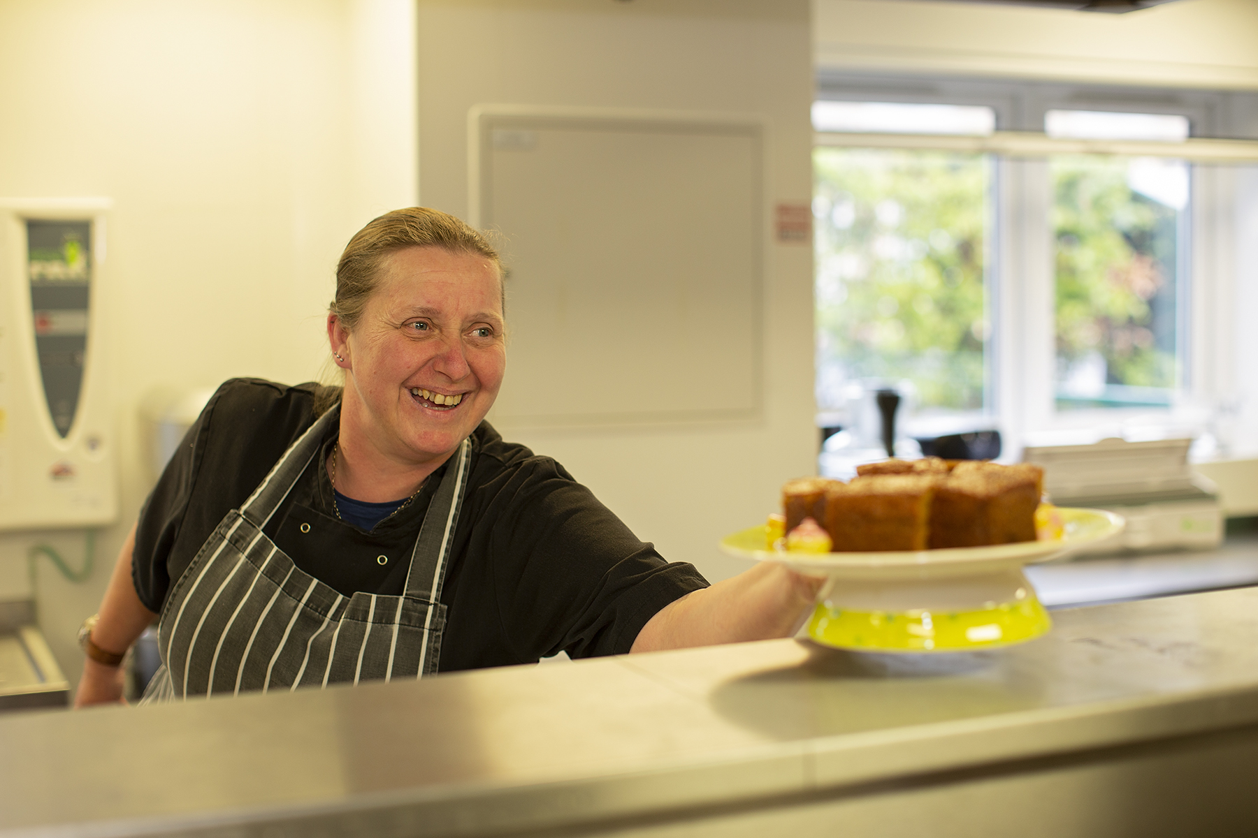 Chef serving cake at Woodcroft Care Home