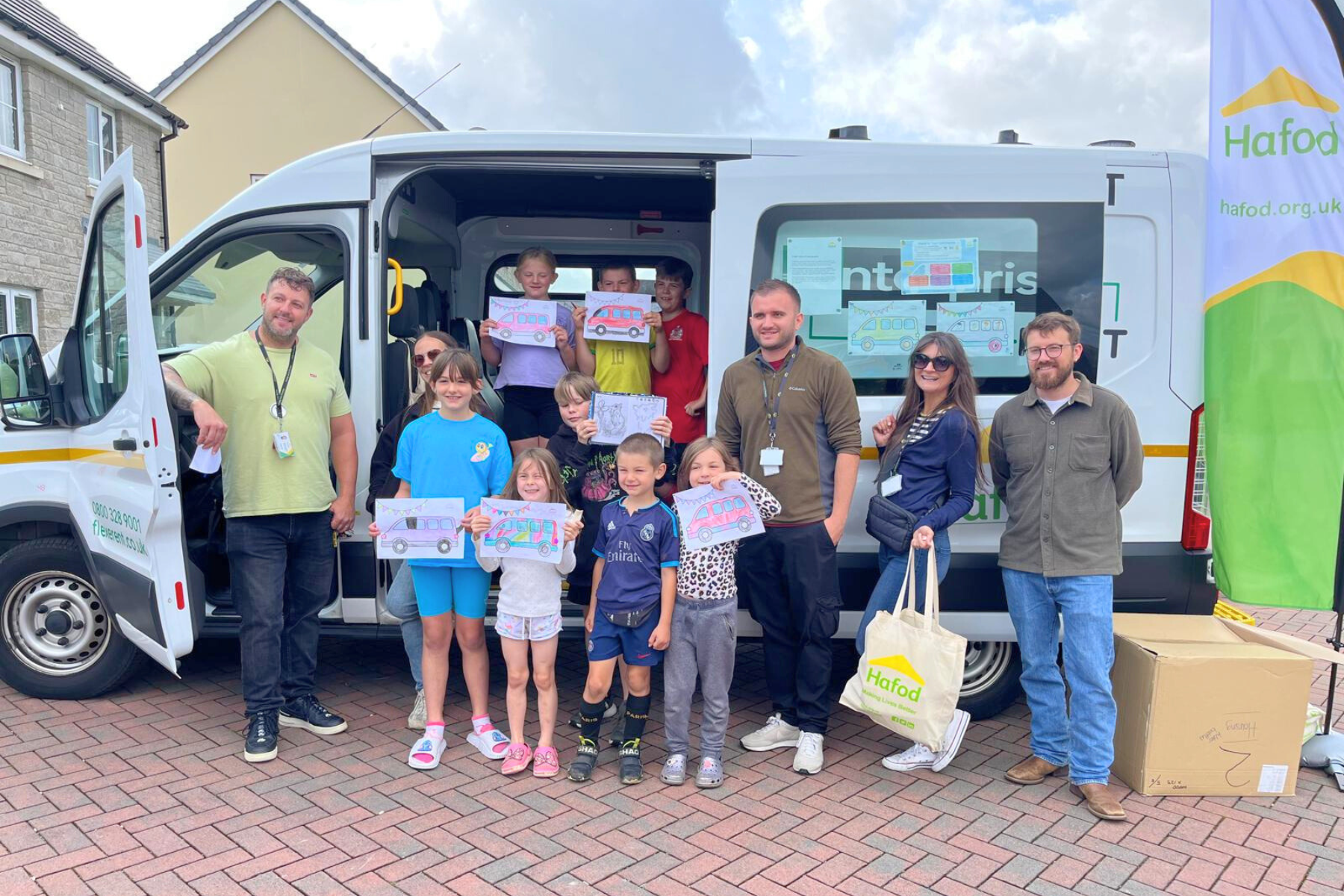 A commnity standing outside a Hafod support minibus