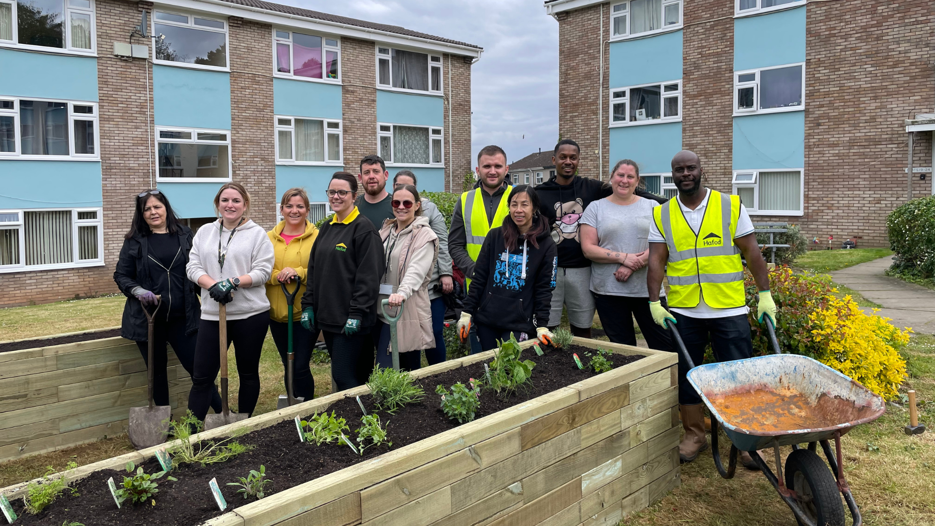A group of resients and volunteers at a raised bedA group of resients and volunteers at a raised bed