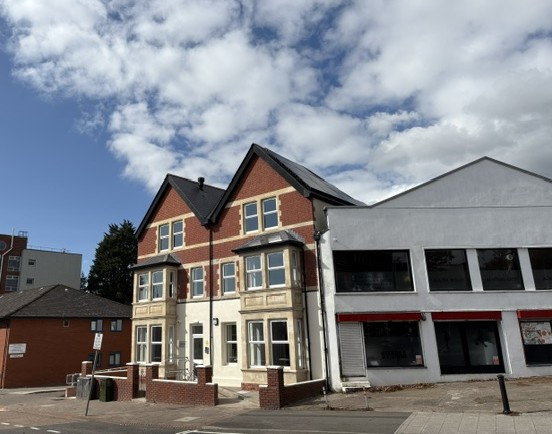 Red brick building with bay windows