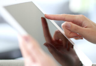 Closeup of hand sliding on digital tablet