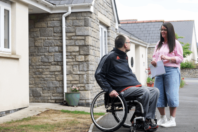 Hafod Housing Association a neighbourhood coach with a tenant outside their home