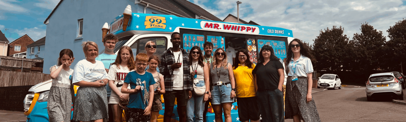Hafod Housing Association customers and colleagues at an event standing infront of an ice cream van