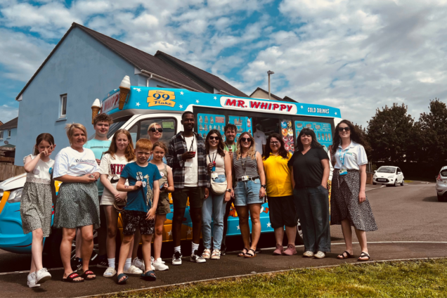 Hafod Housing Association customers and colleagues at an event standing infront of an ice cream van