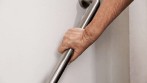 an arm holding a grab rail