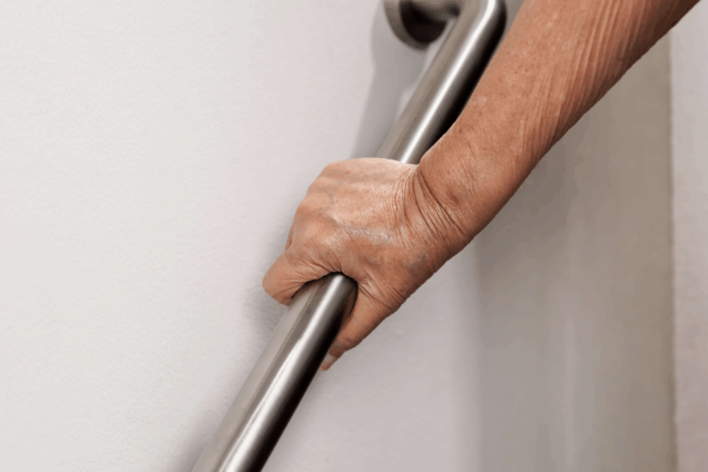 an arm holding a grab rail