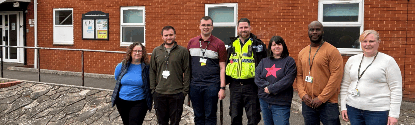 Hafod Housing Association neighbourhood coaches with a PSCO infront of a community centre