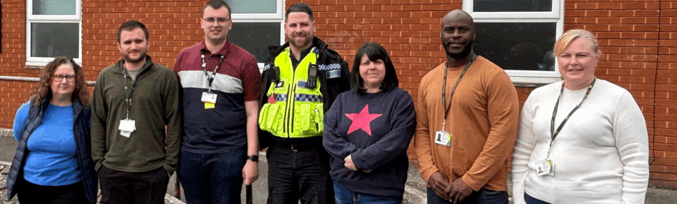 Hafod Housing Association neighbourhood coaches with a PSCO infront of a community centre