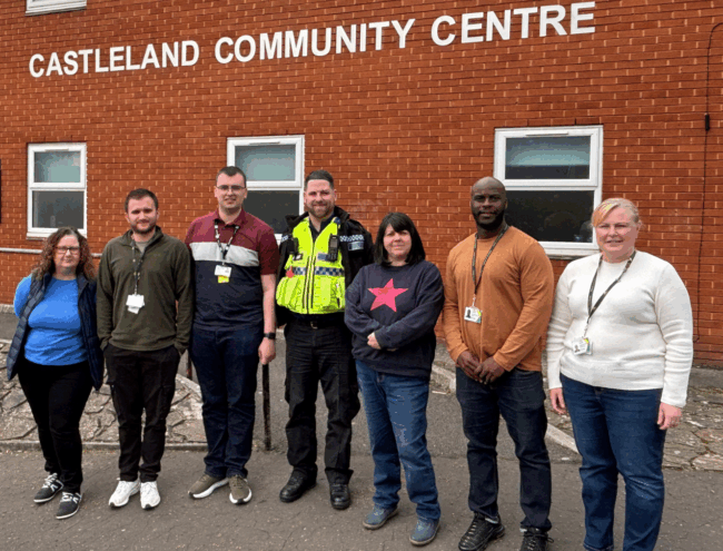 Hafod Housing Association neighbourhood coaches with a PSCO infront of a community centre