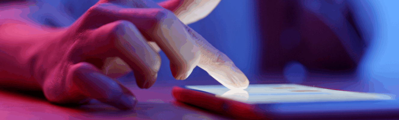 a finger touching a smart phone