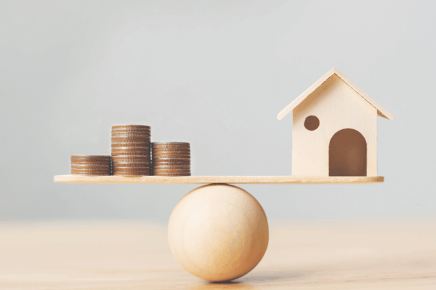 a sphere balancing a home on one side and some coins on the other