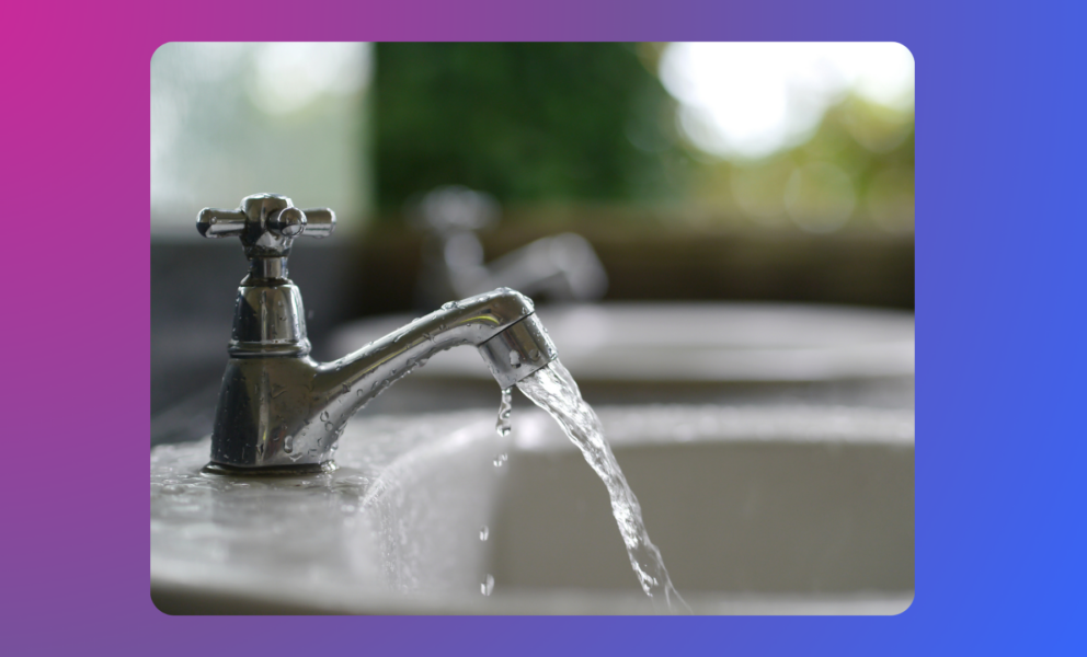 A close up of a tap with water coming out of it