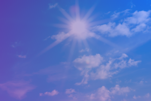 Sun shining in blue sky with some clouds