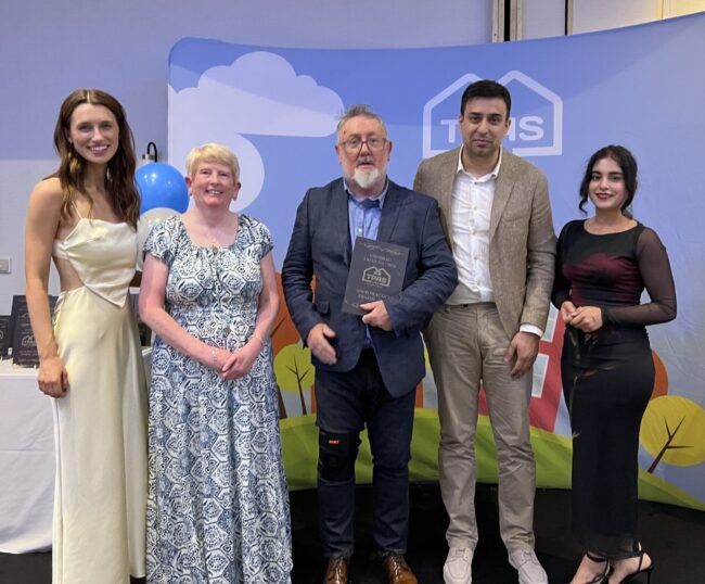 Our Scrutiny Panel and Board memeber recieving their TPAS Cymru award