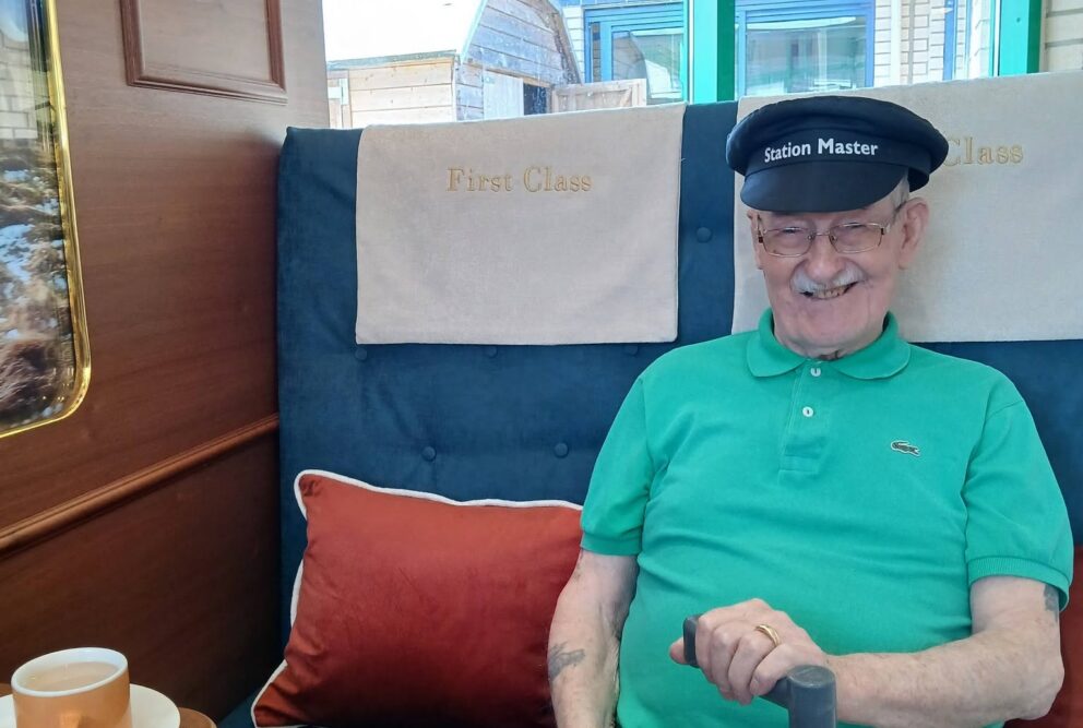 Bernard smiling wearing train drivers hat