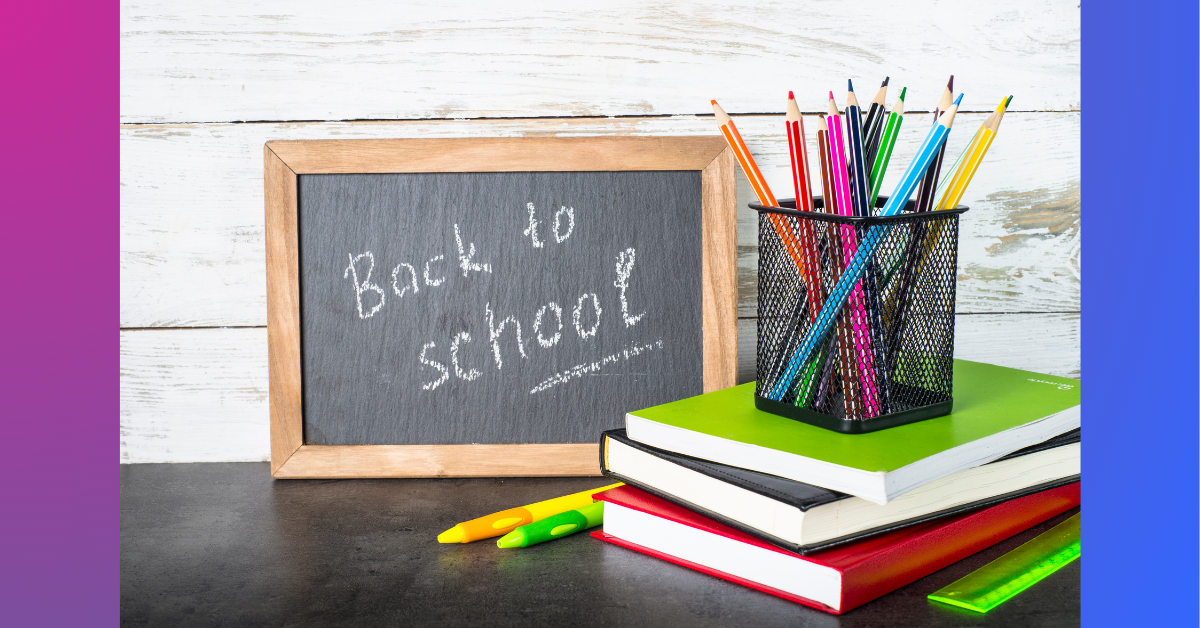 A whiteboard showing the words back to school with some books and pencils