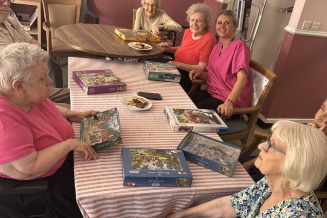 Brocastle Manor Care Home residents sat at table for jigsaw activity
