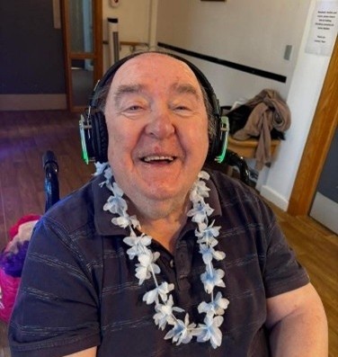 Resident smiling and wearing headphones as part of silent disco